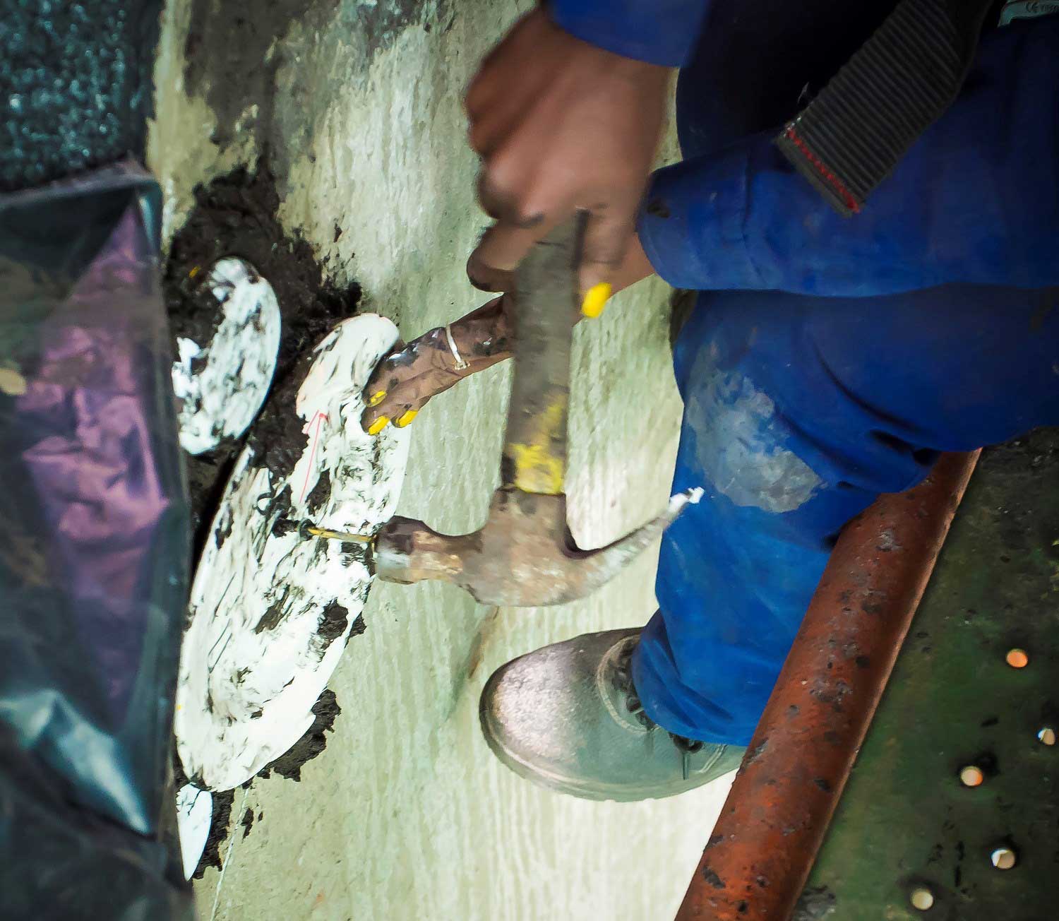Fixing the ceramic pieces to Nzunza House using TAL adhesives and slurry coat