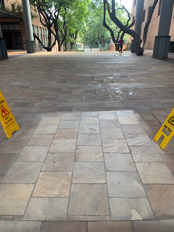 Department of Trade and industry sandstone flooring outside of building with a test area of the rejuvenated natural stone.