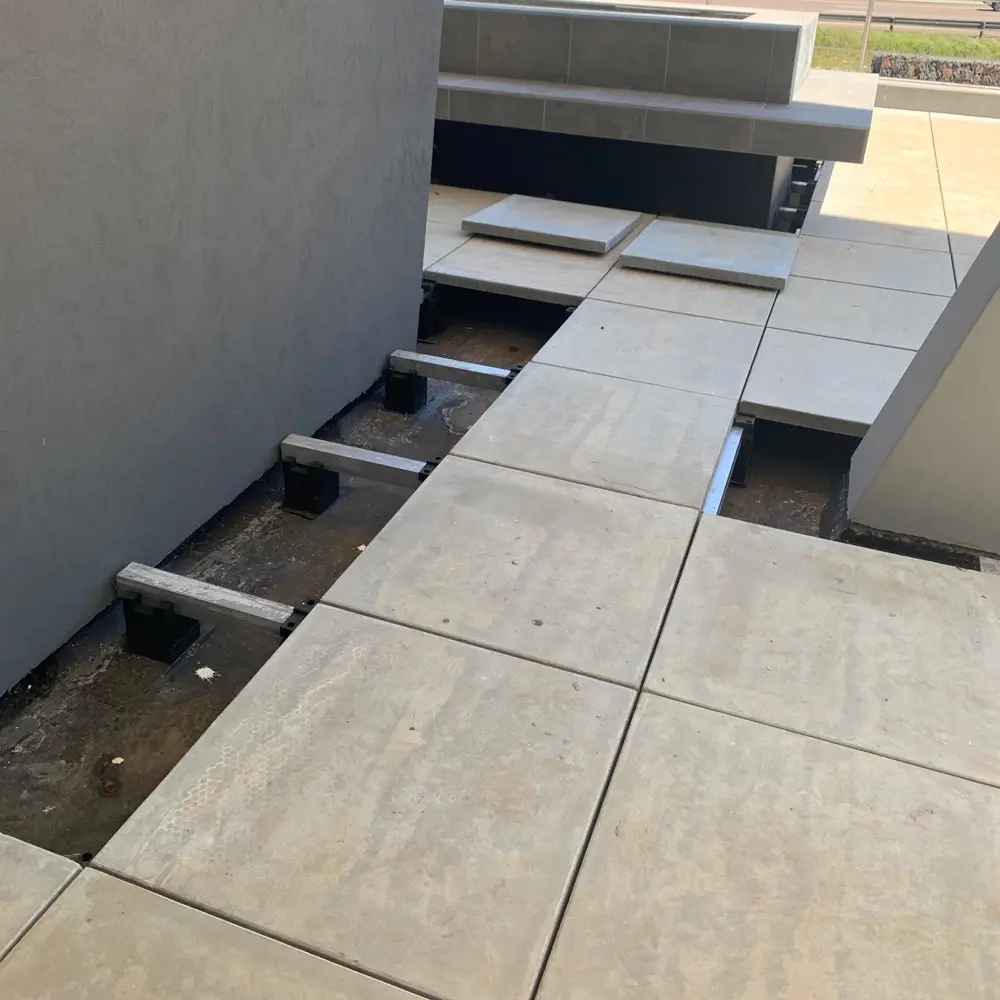Raised deck flooring constructed above the ground level for an outdoor area.