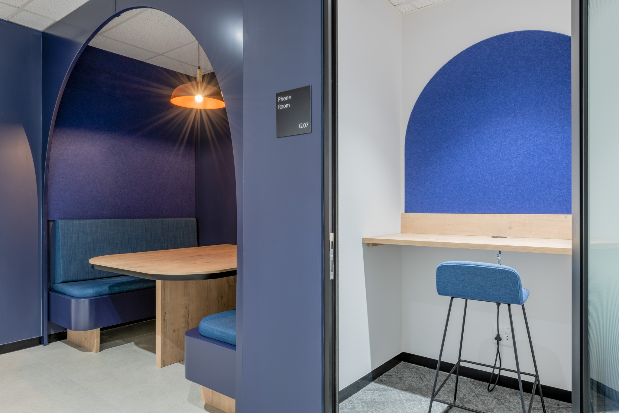 A modern neuro-inclusive office interior featuring acoustic pods, varied working zones and layered lighting designed to support diverse cognitive needs